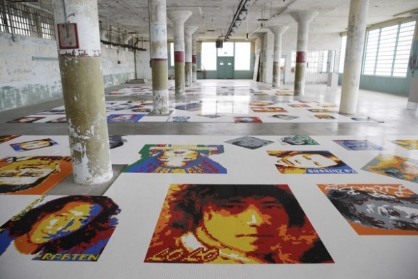 People look at some of the 175 portraits made from Lego pieces in the installation Trace during a preview of the art exhibit @Large: Ai Weiwei on Alcatraz Island Wednesday, Sept. 24, 2014, in San Francisco. Revealing unexpected perspectives on Alcatraz and its layered legacy, the exhibit by the Beijing-based artist prompts visitors to consider the implications of incarceration and the possibilities of art as an act of conscience. The exhibit, which opens Friday and runs through April, features 175 portraits of prisoners of conscience and political exiles around the world, from Nelson Mandela and the Tibetan pop singer Lolo to the American whistle-blower Edward Snowden and composed of 1.2 million Lego pieces. (AP Photo/Eric Risberg)