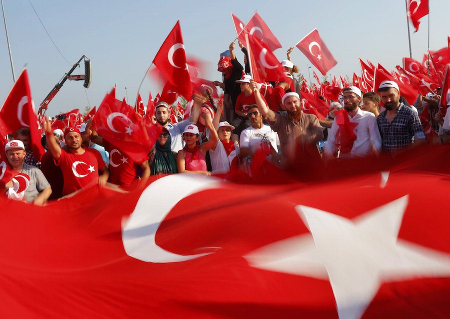 People wave Turkey's national flags during the Democracy and Martyrs Rally in Istanbul