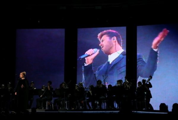 Singer Adele performs a tribute to the late George Michael (on screen) at the 59th Annual Grammy Awards in Los Angeles, California, U.S. , February 12, 2017. REUTERS/Lucy Nicholson