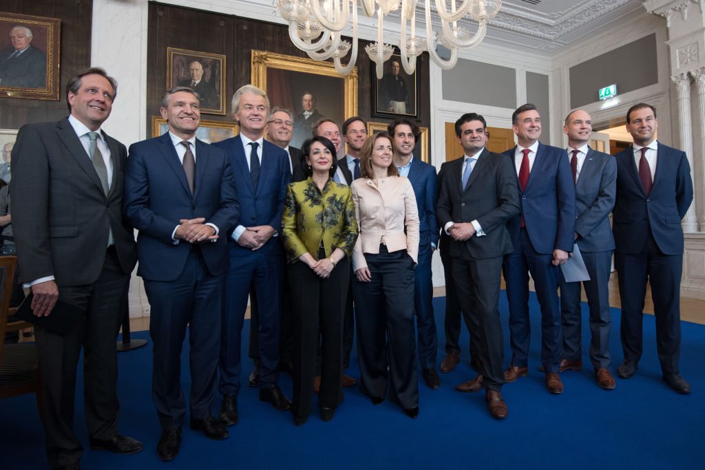 THE HAGUE, NETHERLANDS - MARCH 16: Dutch political party leaders including Party for Freedom (PVV) leader Geert Wilders (3-L) and Prime Minister Mark Rutte (7-L) pose for a group photograph with Speaker of the House of Representatives, Khadija Arib (5-L), as they attend a meeting of Dutch political party leaders at the House of Representatives to express their views on the formation of the cabinet, on March 16, 2017 in The Hague, Netherlands. Prime Minister Mark Rutte was reelected for a second term in yesterday's general election which also saw the right-wing Party for Freedom (PVV) led by Geert Wilders become the country's second largest party. (Photo by Carl Court/Getty Images)