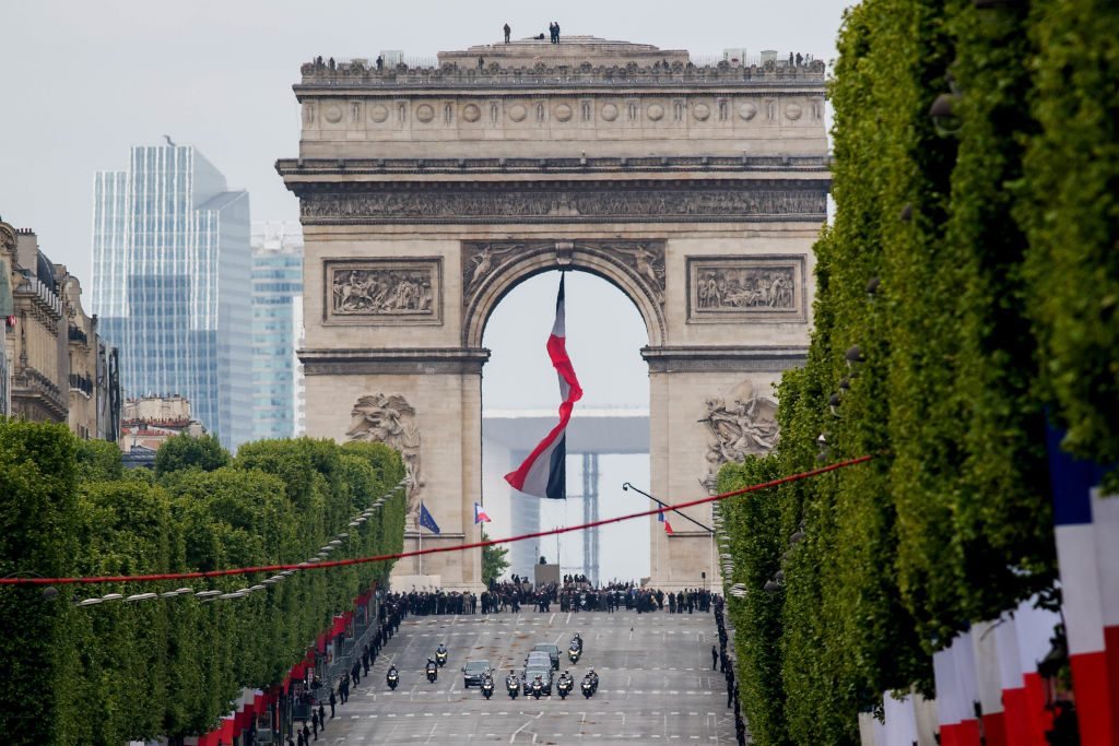 PARIS, FRANCE - MAY 08: The motorcade of French president-elect Emmanuel Macron and outoing president Francois Hollande drives down the Champs Elysse after attending the ceremony to mark Western allies' World War Two victory in Europe on May 8, 2017 in Paris, France. The ceremony marks the 72nd anniversary of the victory over Nazi Germany in 1945. (Photo by David Ramos/Getty Images)