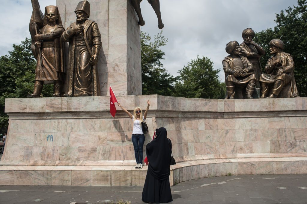 ISTANBUL, TURKEY - JULY 14: A woman poses for a photograph after attending a rally to honour the victims of the July 15, 2016 coup attempt a day ahead of the first anniversary of the failed coup attempt on July 14, 2017 in Istanbul, Turkey. July 15, 2017 will mark the first anniversary of the failed coup attempt which saw 249 people die when military personnel attempted to over throw the government and President Recep Tayyip Erdogan. Extensive commemorations have been planned for the July 15 anniversary and the day has been declared an annual holiday. (Photo by Chris McGrath/Getty Images)