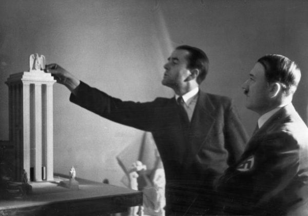 Dr. Albert Speer (left), Hitler's chief architect, presents his model of the German Pavilion, designed for the World's Fair in Paris in 1937. Date: 1937
