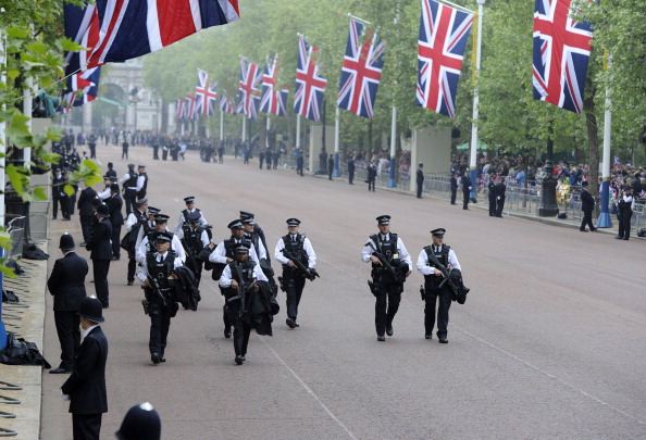 LONDON, ENGLAND - APRIL 29: Armed police officers patrol The Mall before members of the royal wedding party travel to Westminster Abbey for marriage of Prince William and Catherine Middleton on April 29, 2011 in London, England. The marriage of Prince William, the second in line to the British throne, to Catherine Middleton, is to be led by the Archbishop of Canterbury and will be attended by 1900 guests, including foreign Royal family members and heads of state. Thousands of well-wishers from around the world have also flocked to London to witness the spectacle and pageantry of the Royal Wedding. (Photo by Paul Hackett - WPA Pool/Getty Images)