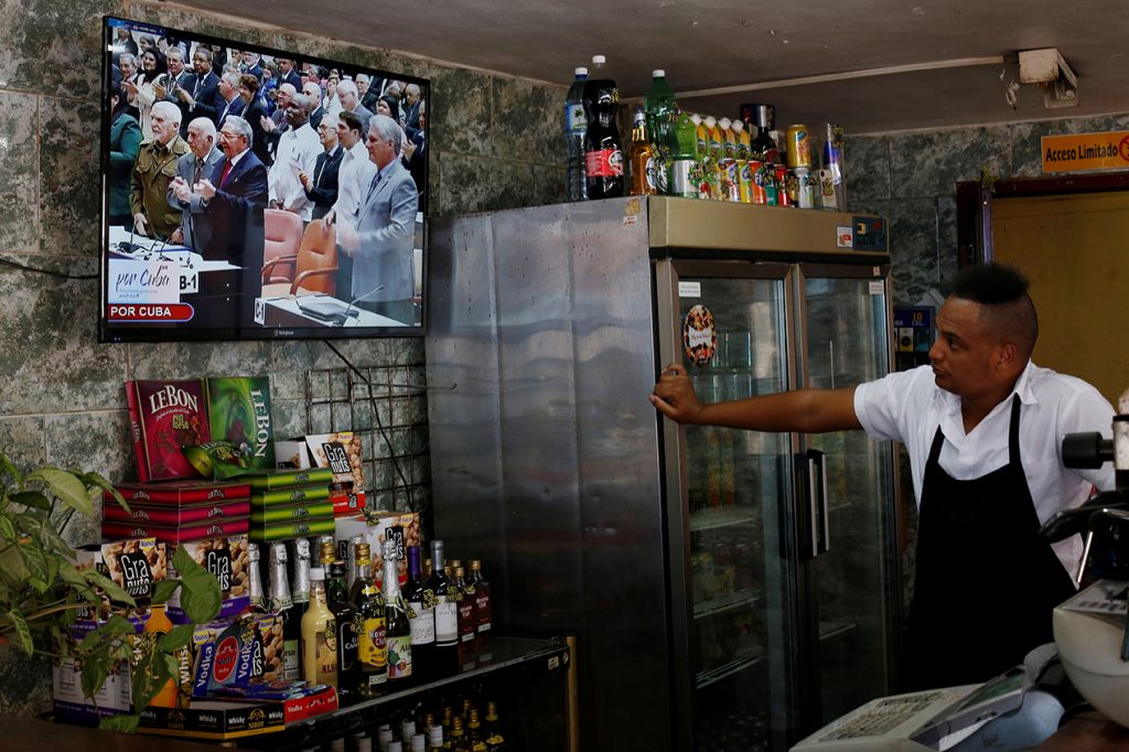 Cuba's President Raul Castro (C) and First Vice-President Miguel Diaz-Canel (R) are seen on a TV screen inside a restaurant during a session of the National Assembly in Havana, Cuba, April 18, 2018. REUTERS/Stringer NO RESALES. NO ARCHIVE