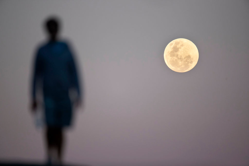 SYDNEY, NEW SOUTH WALES - JULY 27: The full moon rises near Bondi Beach ahead of a total lunar eclipse, on July 27, 2018 in Sydney, Australia. The period of totality during this eclipse, when Earth's shadow is directly across the moon and it is at its reddest, will last 1 hour, 42 minutes and 57 seconds, making it the longest viewable lunar eclipse this century. (Photo by Brook Mitchell/Getty Images)